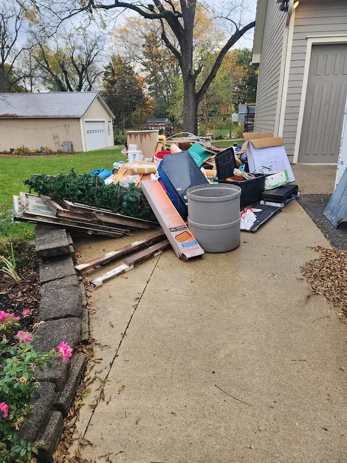 Dumpster being loaded with debris for Commercial Dumpster Rental in Pontiac